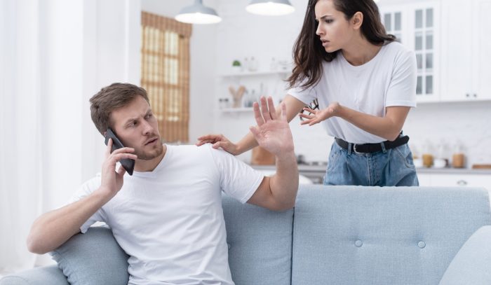 woman-arguing-with-her-boyfriend-while-he-is-talking-phone