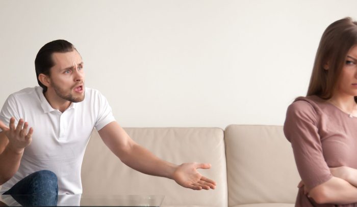 Unhappy young couple quarrelling indoor, aggressive angry boyfriend shouting at offended sad wife, lady with arms crossed. Constant family conflicts. Horizontal photo banner for website header design